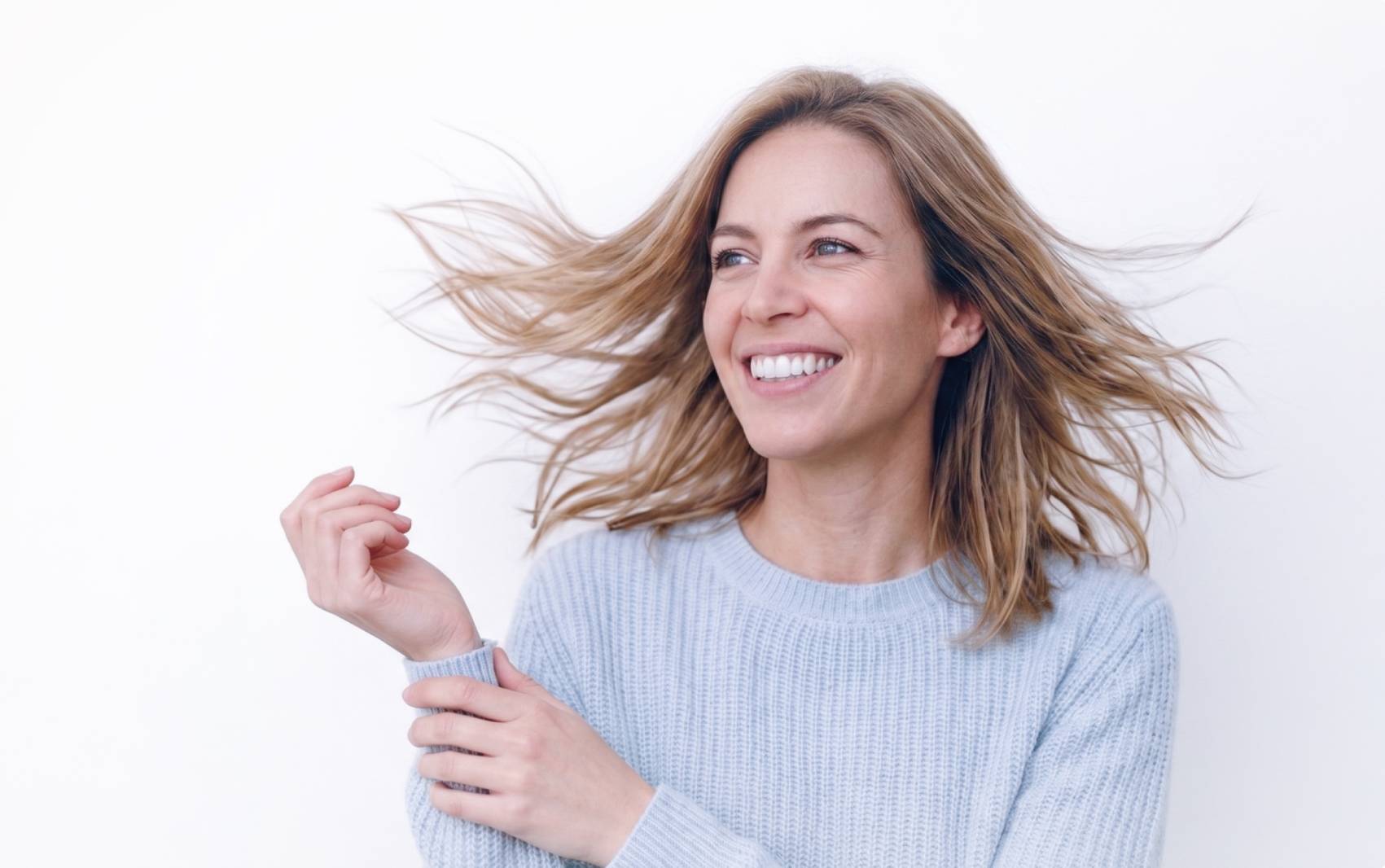 Smiling woman with windswept hair Smiling woman with windswept hair